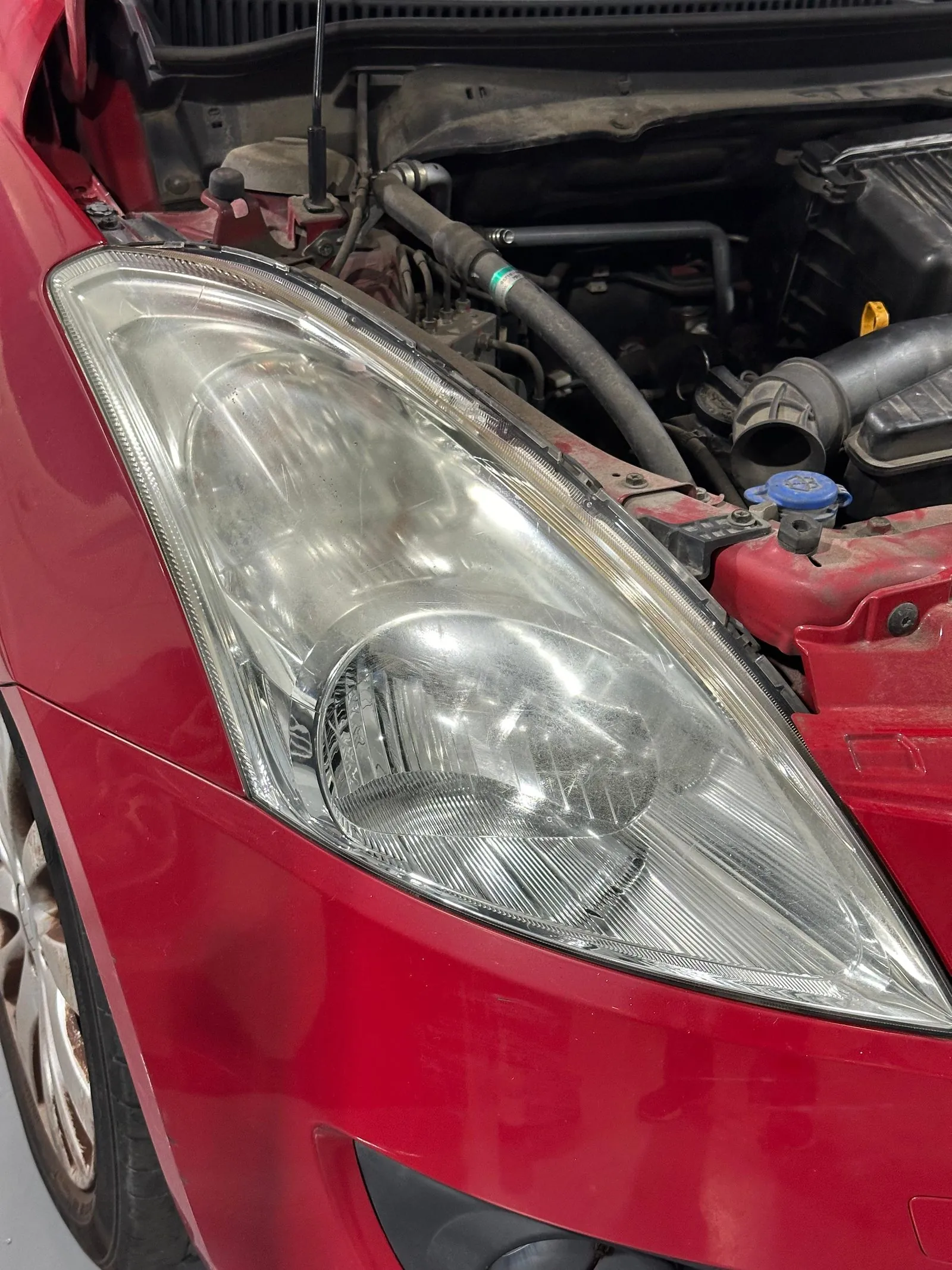 Faro amarillento en coche rojo antes del pulido profesional · FR Deluxe Barcelona