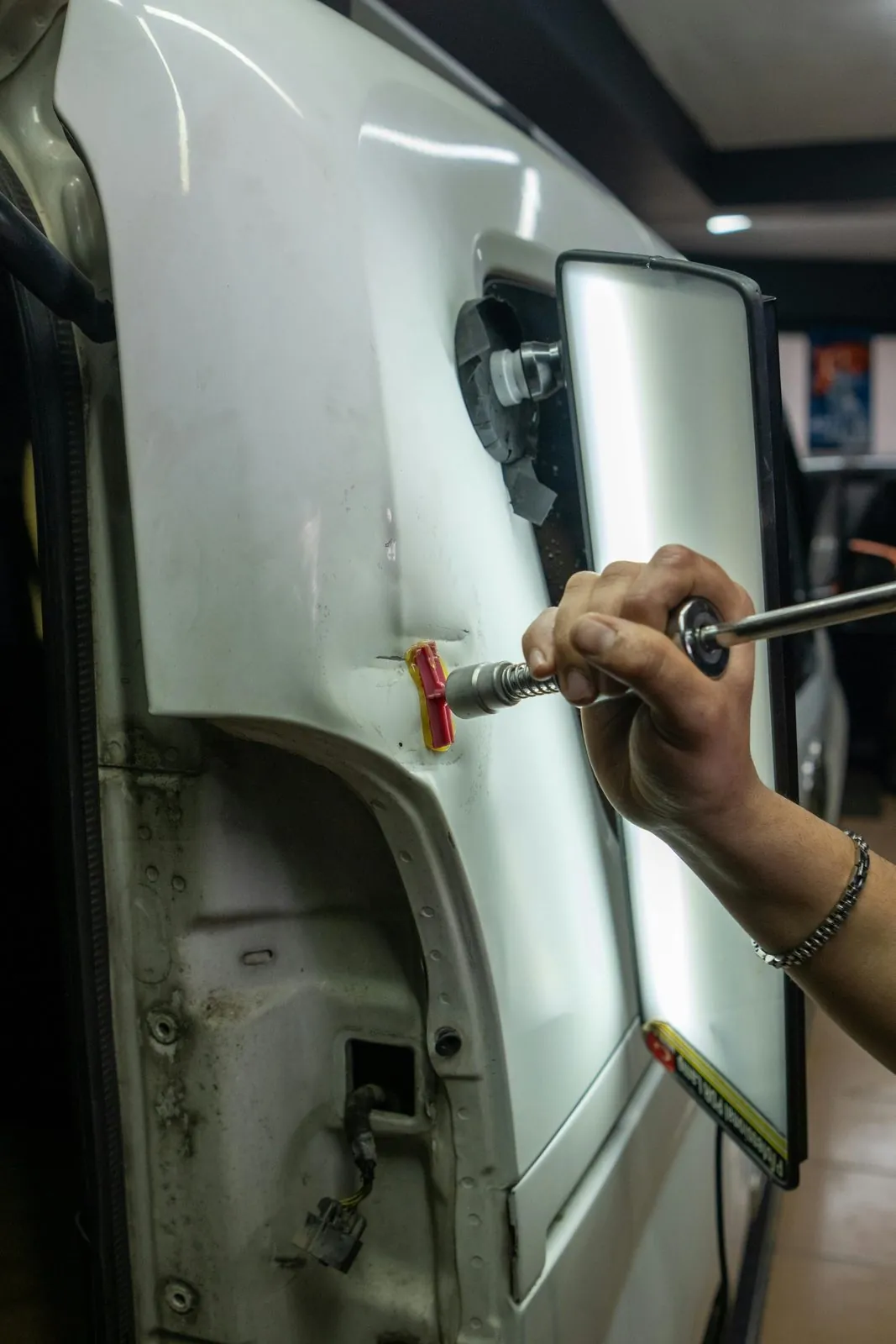 Varillero trabajando en una reparación PDR con extractor en Barcelona · FR Deluxe